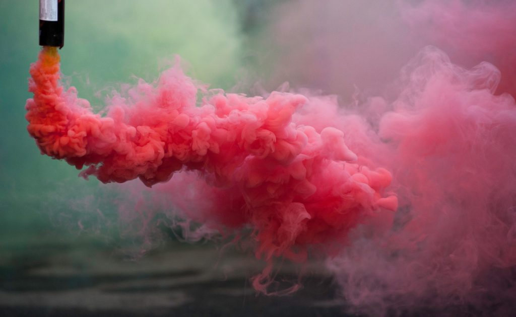 coloroful pink smoke bombs in action